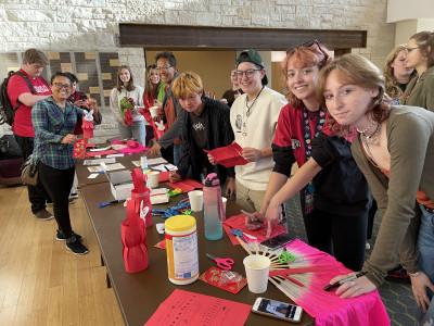 Students, faculty, and community members make paper lanterns to celebrate the Mid-Autumn Festival...